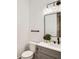 Clean and modern half bathroom with a gray vanity, black fixtures, and neutral decor at 1523 Grayson Pkwy, Grayson, GA 30017