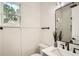 Modern bathroom features sleek fixtures, a stylish mirror, and natural light, creating a spa-like experience at 1523 Grayson Pkwy, Grayson, GA 30017