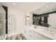 Luxurious bathroom with dual vanities, a large mirror, and a glass-enclosed shower, offering a spa-like experience at 1523 Grayson Pkwy, Grayson, GA 30017
