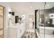 Modern bathroom featuring dual sinks, stylish fixtures, and a glass shower, creating a serene and luxurious space at 1523 Grayson Pkwy, Grayson, GA 30017
