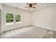 Bright bedroom with carpet floors, geometric accent wall, and two windows offering natural light at 1523 Grayson Pkwy, Grayson, GA 30017