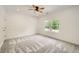 Contemporary bedroom features an accent wall, carpet, natural lighting and a ceiling fan, creating a comfortable retreat at 1523 Grayson Pkwy, Grayson, GA 30017
