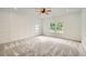 Bright bedroom featuring neutral carpet, ceiling fan, paneling, and natural light from multiple windows at 1523 Grayson Pkwy, Grayson, GA 30017