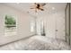 Bright bedroom featuring carpet flooring, a ceiling fan, and a modern design, creating a cozy and stylish space at 1523 Grayson Pkwy, Grayson, GA 30017