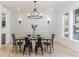 Elegant dining room features a modern chandelier, wainscoting, and large windows at 1523 Grayson Pkwy, Grayson, GA 30017