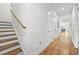 Hallway with hardwood floors, a staircase, and white walls at 3279 Elm St, College Park, GA 30337