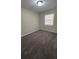 Bedroom featuring neutral walls, carpet, and a window at 4100 Seneca Way, Stone Mountain, GA 30083