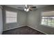 Corner bedroom featuring carpeting, windows, and neutral paint at 4100 Seneca Way, Stone Mountain, GA 30083