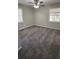 Bright bedroom featuring two windows, ceiling fan, and soft carpeting at 4100 Seneca Way, Stone Mountain, GA 30083