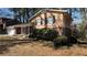 A charming house with a well-manicured lawn and complemented by the natural beauty of surrounding trees at 4100 Seneca Way, Stone Mountain, GA 30083