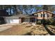 Charming home with brick accents, a well-maintained lawn, and an attached two-car garage at 4100 Seneca Way, Stone Mountain, GA 30083