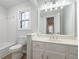 This bathroom features an extra large mirror, white vanity, and tub/shower combo at 5086 Stoneywood Se Cir, Mableton, GA 30126