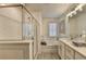 Modern bathroom featuring double vanity, glass shower, and soaking tub with tile backsplash at 172 Ne Almand Ln, Conyers, GA 30013