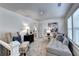 Bright bedroom featuring cozy chaise lounge, stylish accent chair, and neutral decor at 172 Ne Almand Ln, Conyers, GA 30013