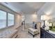 Upstairs hallway with a chair, bench, cabinet, and a window that lets in lots of natural light at 172 Ne Almand Ln, Conyers, GA 30013