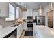 Bright eat-in kitchen featuring white cabinetry, stainless steel appliances, an island, and lots of natural light at 172 Ne Almand Ln, Conyers, GA 30013