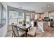 Bright eat-in kitchen featuring stainless steel appliances, a large island, and a dining table set by the window at 172 Ne Almand Ln, Conyers, GA 30013