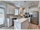 Modern kitchen featuring stainless steel appliances, white cabinets, and a center island at 172 Ne Almand Ln, Conyers, GA 30013