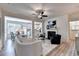 Bright living room with a ceiling fan, fireplace, and an open concept that connects to the kitchen and breakfast nook at 172 Ne Almand Ln, Conyers, GA 30013