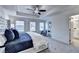 Spacious bedroom featuring tray ceilings, large windows and luxurious blue bedding at 2700 Ne Almand Ln, Conyers, GA 30013