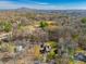 Aerial view of a neighborhood showcasing homes with mature trees and foliage at 2421 Pittman Cir, Cumming, GA 30040