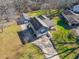 Aerial view of a gray home with a large driveway and a two-car garage surrounded by trees at 2421 Pittman Cir, Cumming, GA 30040