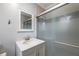 Bathroom featuring a modern vanity, mirror and glass enclosed shower at 2421 Pittman Cir, Cumming, GA 30040