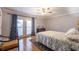 Bedroom featuring french doors to an outdoor balcony with hardwood floors at 2421 Pittman Cir, Cumming, GA 30040