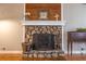 The stone fireplace features a hearth, white mantle, wood accents, and decorative details at 2421 Pittman Cir, Cumming, GA 30040