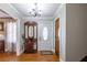 Inviting foyer with hardwood floors, a decorative mirror, and neutral wall paint at 2421 Pittman Cir, Cumming, GA 30040