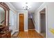 Bright foyer featuring hardwood floors, a staircase, and a decorative chandelier at 2421 Pittman Cir, Cumming, GA 30040