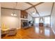 Open living room with a vaulted ceiling, stone fireplace, and hardwood floors at 2421 Pittman Cir, Cumming, GA 30040