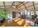 Dining area in sunroom filled with natural light and views of nature at 2421 Pittman Cir, Cumming, GA 30040