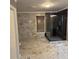 Well-lit bathroom featuring glass shower, marble wall tiles, and a window with wood blinds at 471 Tipton Dr, Riverdale, GA 30274