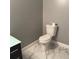 Modern half-bathroom with marble floors, a toilet and a dark vanity at 471 Tipton Dr, Riverdale, GA 30274