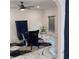 Stylish dining area featuring an elegant chair, glass table and a modern ceiling fan at 471 Tipton Dr, Riverdale, GA 30274