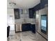 A stylish modern kitchen with dark blue cabinets and stainless steel appliances at 471 Tipton Dr, Riverdale, GA 30274