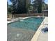 Sparkling in-ground swimming pool with a volleyball net, complemented by a stone spa for ultimate relaxation at 471 Tipton Dr, Riverdale, GA 30274