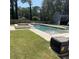 Relaxing pool area with a volleyball net and a spa in the background, ideal for summer fun at 471 Tipton Dr, Riverdale, GA 30274