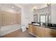 Well-lit bathroom with a tub-shower combo, tile backsplash, and a modern vanity with granite countertops at 5300 Peachtree Rd # 3507, Chamblee, GA 30341