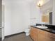 Bathroom featuring tile floors, a large mirror, a marble countertop, and wood cabinets at 5300 Peachtree Rd # 3507, Chamblee, GA 30341