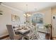 Formal dining room featuring a large window, elegant chandelier, and stylish table setting at 7420 Glisten Ave, Sandy Springs, GA 30328