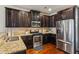 Stylish kitchen with stainless steel appliances, granite countertops, and rich wood cabinetry at 7420 Glisten Ave, Sandy Springs, GA 30328