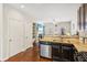 Open kitchen offers stainless appliances, granite countertops, and hardwood floors, flowing into the living area at 7420 Glisten Ave, Sandy Springs, GA 30328