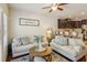 Open-concept living room with kitchen view, comfortable sofas, hardwood floors, and stylish decor at 7420 Glisten Ave, Sandy Springs, GA 30328