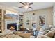Bright living room featuring a fireplace, built-in shelves, comfortable seating, and natural light at 7420 Glisten Ave, Sandy Springs, GA 30328
