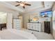This bright main bedroom is a calming retreat, featuring a ceiling fan and updated dressers and cabinets at 7420 Glisten Ave, Sandy Springs, GA 30328
