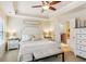 Serene main bedroom features tray ceiling, neutral tones, and a glimpse into the ensuite bathroom at 7420 Glisten Ave, Sandy Springs, GA 30328