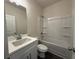 Bathroom featuring a shower-tub combo, white cabinets, and modern fixtures at 5455 Blossomwood Sw Trl, Mableton, GA 30126