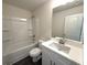 Bright bathroom with a white vanity, modern fixtures, and a combination tub and shower at 5455 Blossomwood Sw Trl, Mableton, GA 30126